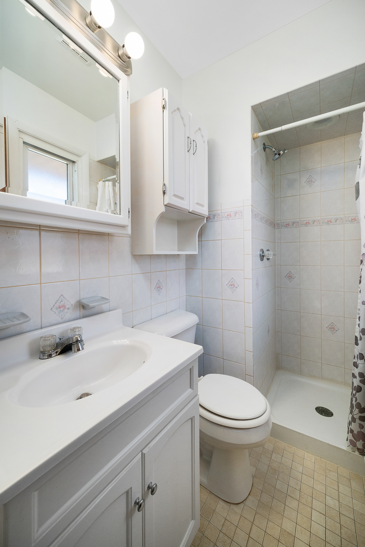 149 Mellbrook Road Bolingbrook, IL 60440 - Photo 14 of 17 a bathroom with a sink a toilet and shower