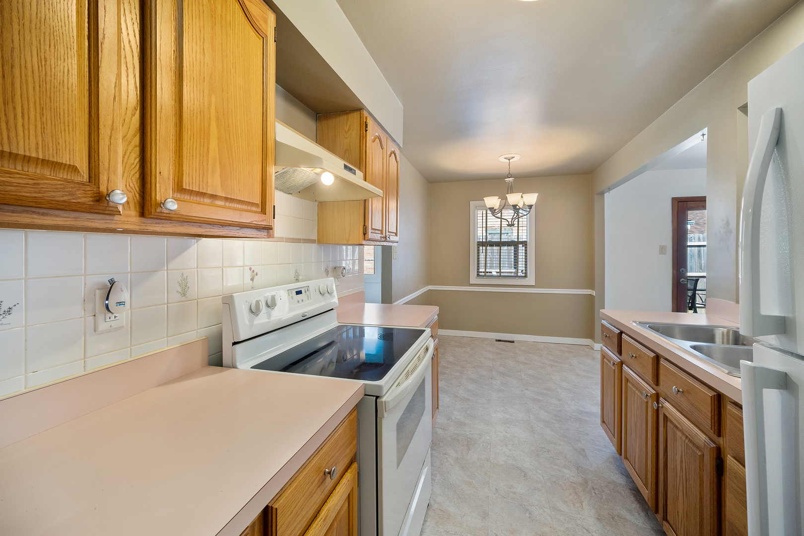 149 Mellbrook Road Bolingbrook, IL 60440 - Photo 3 of 17 a kitchen that has a sink and a stove