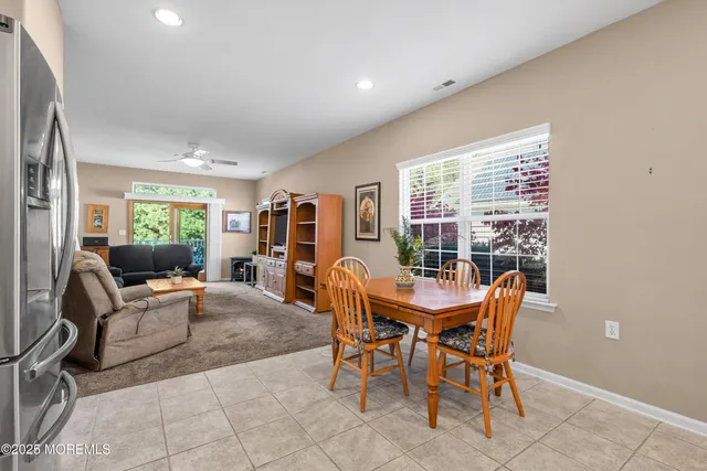 a dining room with furniture and window
