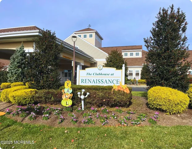 a living room with fireplace furniture and large windows