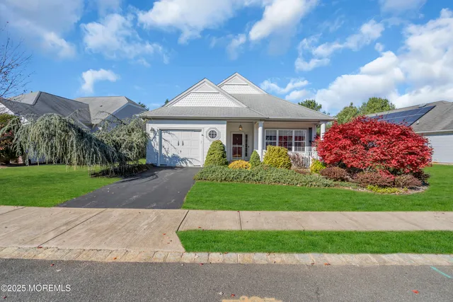 a front view of house with yard and green space