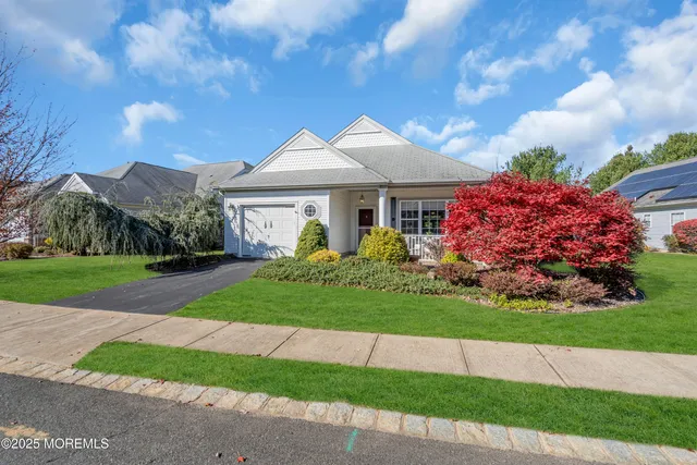 a front view of a house with a garden