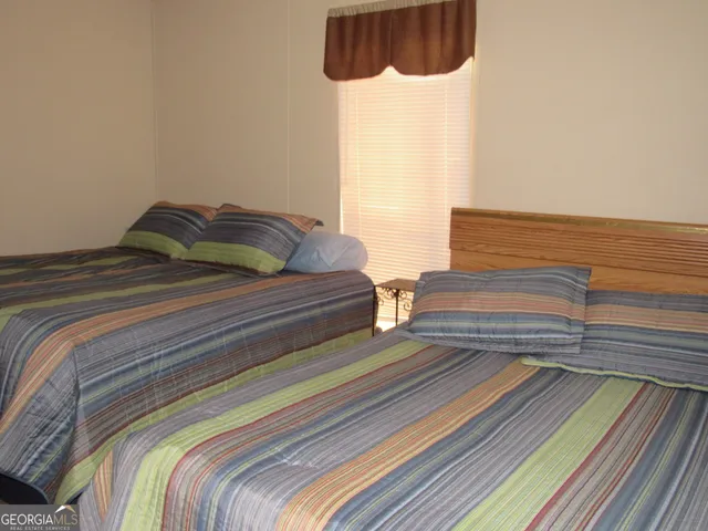 a bedroom with double bed and a window