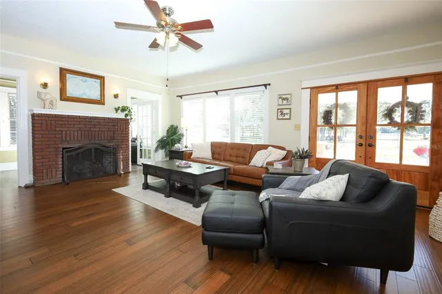 a kitchen with a table chairs and wooden floor