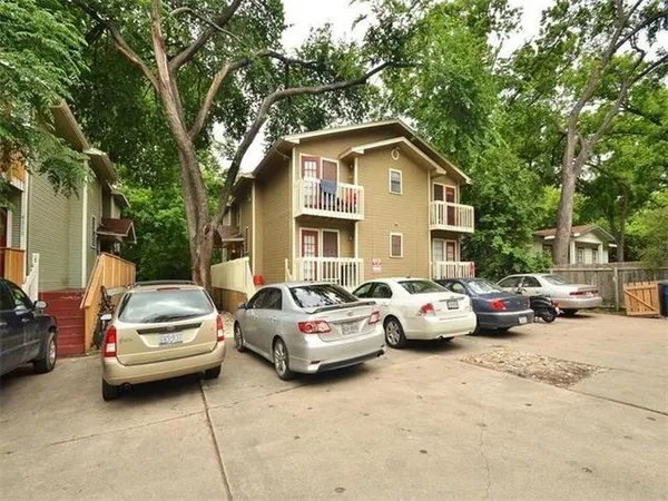 a couple of cars parked in front of a house