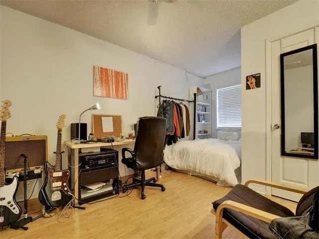 a bedroom with a bed and a flat screen tv