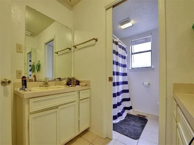 a bathroom with a sink a mirror and shower