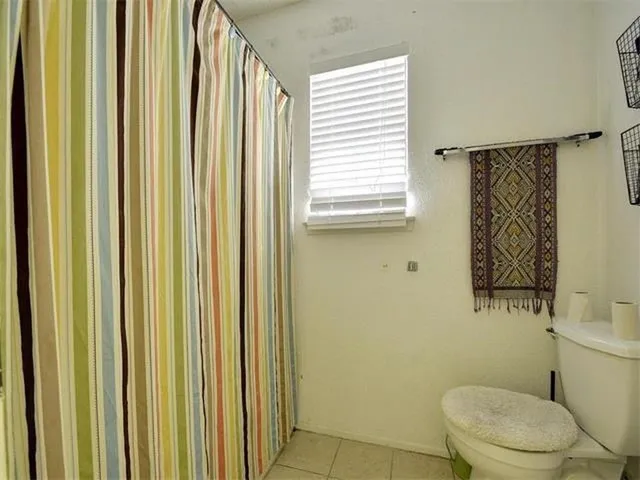 a white toilet sitting next to a bathroom sink