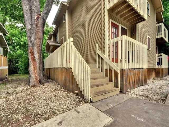a view of small house with wooden fence