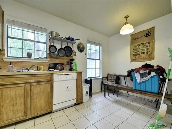 a kitchen with cabinets and chairs