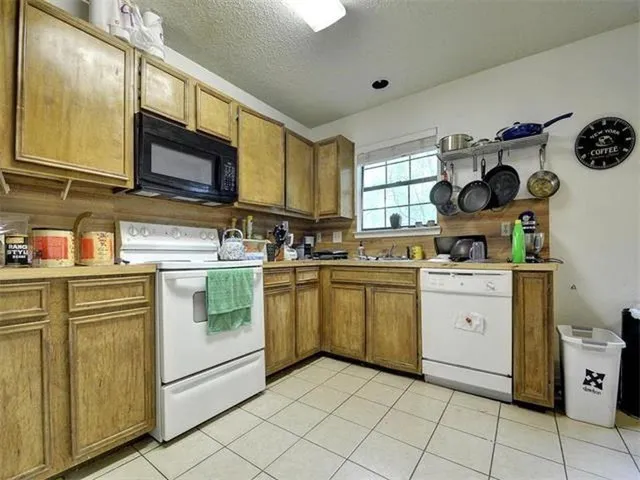 a kitchen with a sink cabinets and window