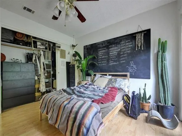 a bedroom with a bed and ceiling fan