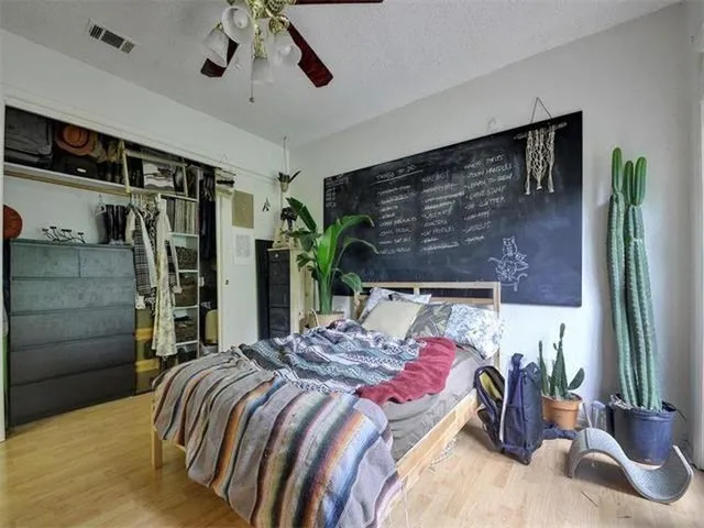 a bedroom with a bed and ceiling fan