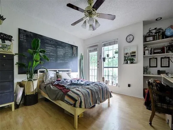 a bedroom with a bed and a chandelier
