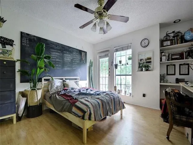 a bedroom with a bed and a chandelier