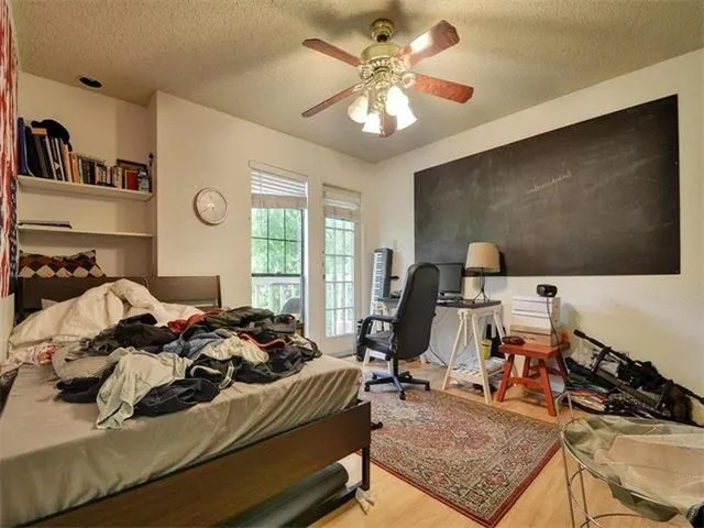 a bedroom with furniture and a flat screen tv
