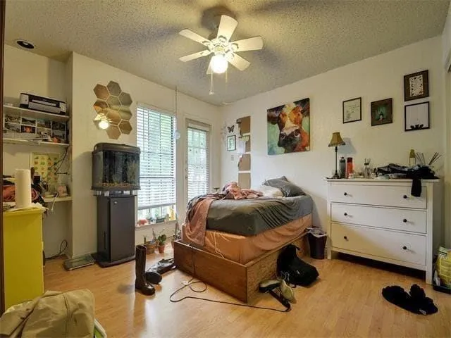 a spacious bedroom with a bed and a chandelier