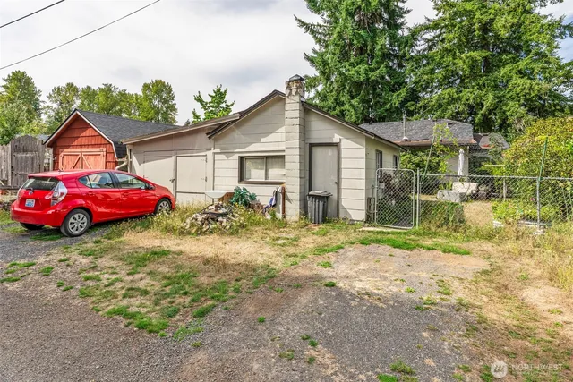 a backyard of a house with table and chairs