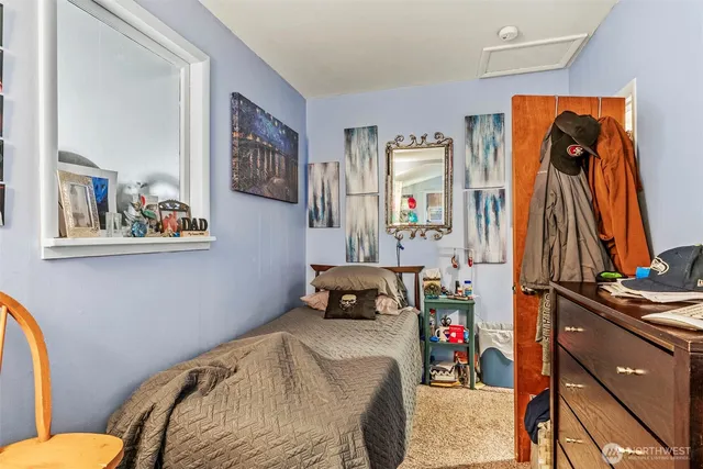 a bedroom with bed and a closet