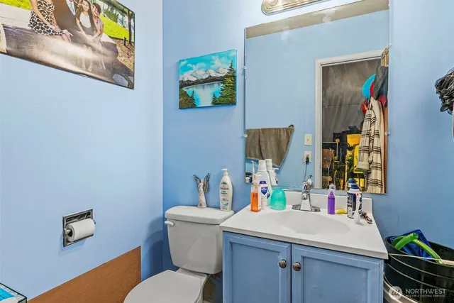 a bathroom with a sink vanity mirror and toilet