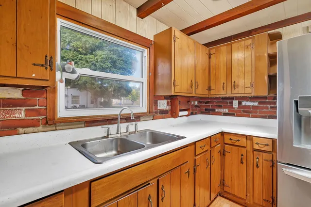 a kitchen with stainless steel appliances granite countertop a sink and a window