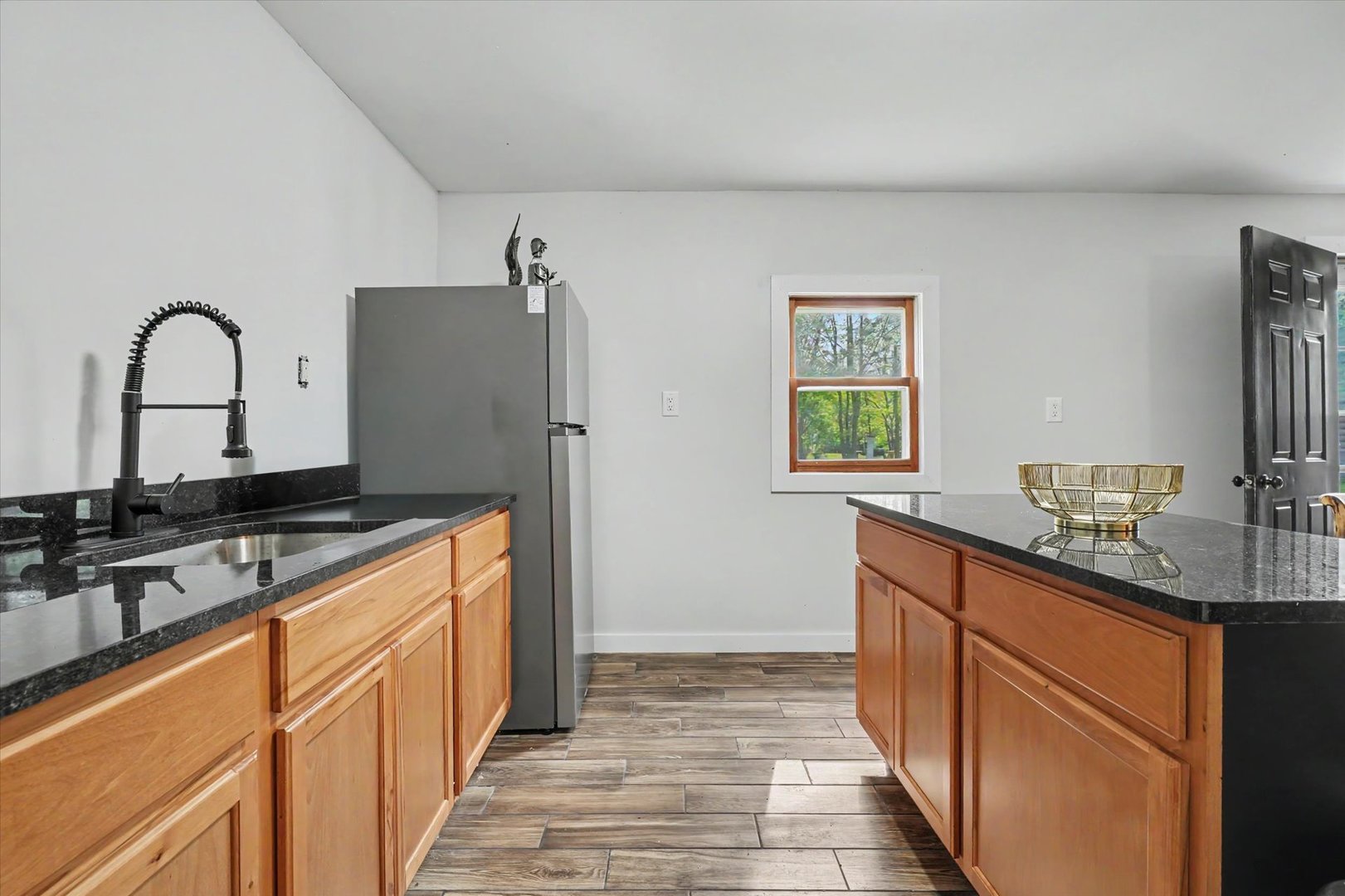 2431 North 1450 East Road Mansfield, IL 61854 - Photo 51 of 78 a kitchen with stainless steel appliances granite countertop a sink stove and refrigerator
