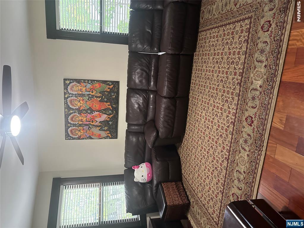 23 Highland Cross, Unit 1 Rutherford, NJ 07070 - Photo 3 of 11 a living room with furniture window and couch