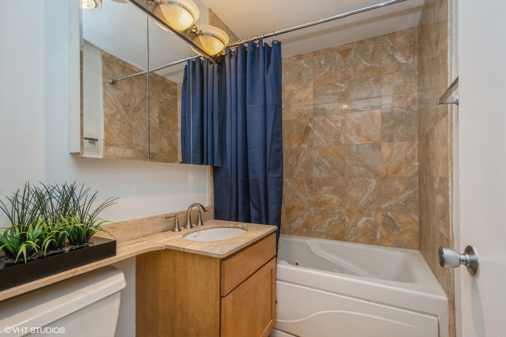 655 West Irving Park Road, Unit 5511 Chicago, IL 60613 - Photo 11 of 29 a bathroom with a granite countertop sink and a bathtub
