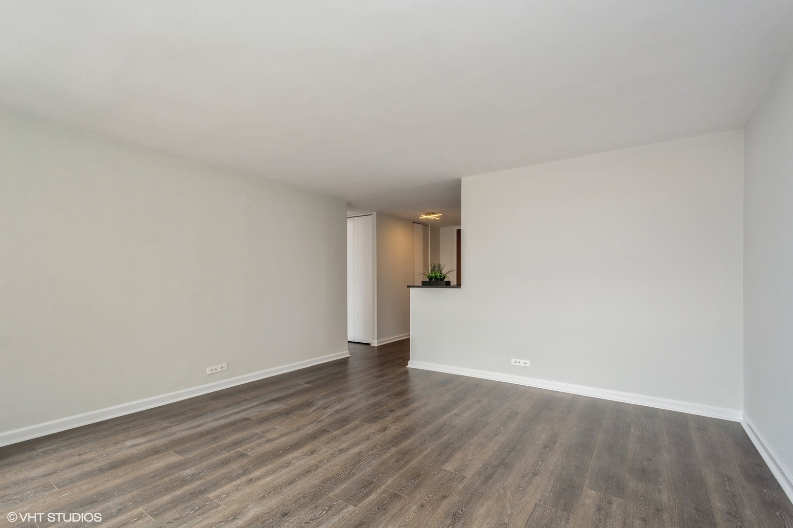 655 West Irving Park Road, Unit 5511 Chicago, IL 60613 - Photo 5 of 29 a view of a big room with wooden floor and a window
