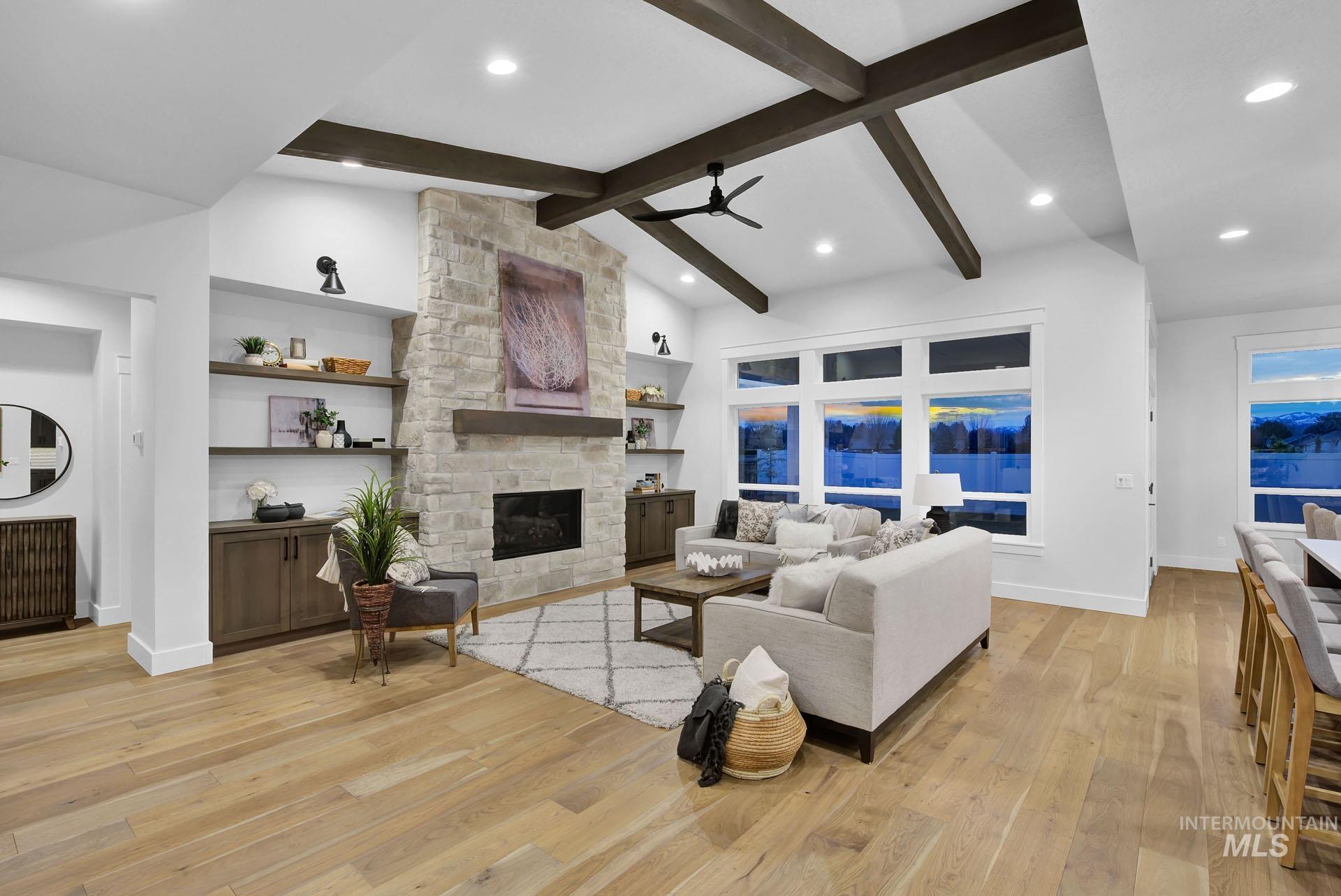 1911 West Timberstone Drive Eagle, ID 83616 - Photo 3 of 15 Living area featuring light wood-style flooring, a ceiling fan, a fireplace, and recessed lighting
