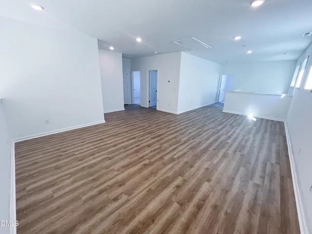 a view of a patio with a table chairs and a floor to ceiling window