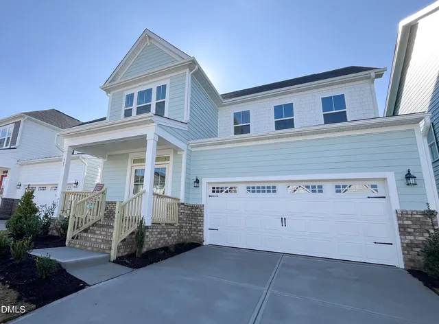 a front view of a house with a garage