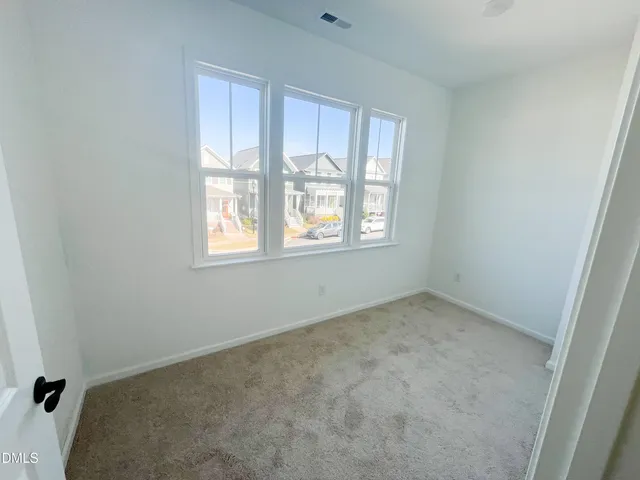 a view of a balcony with two chairs and wooden floor