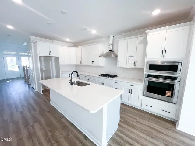 a living room with a fireplace and a floor to ceiling window