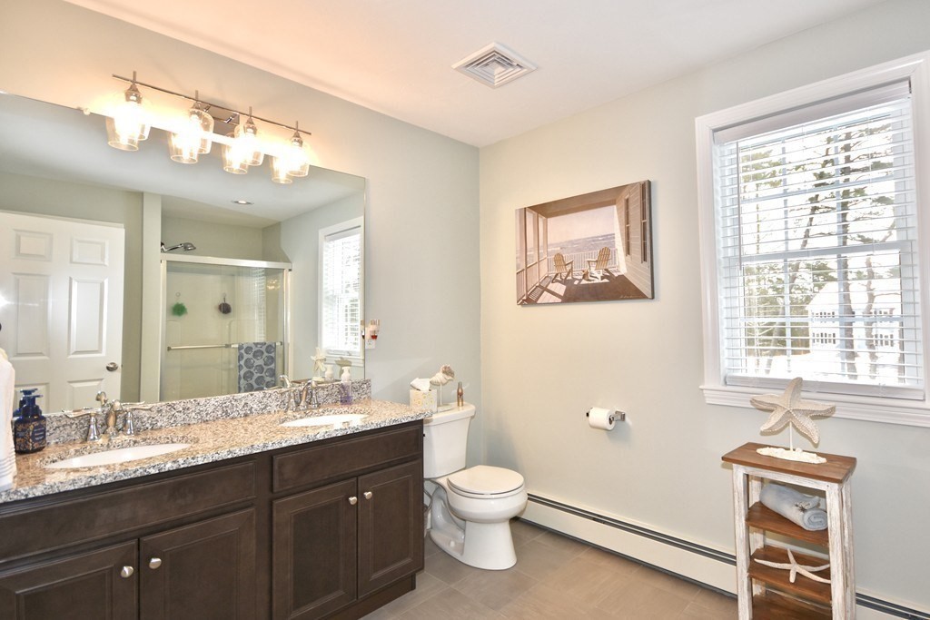 Lot 58-235 Forbes Road Rochester, MA 02770 - Photo 6 of 12 a bathroom with a toilet a sink a mirror a window and vanity