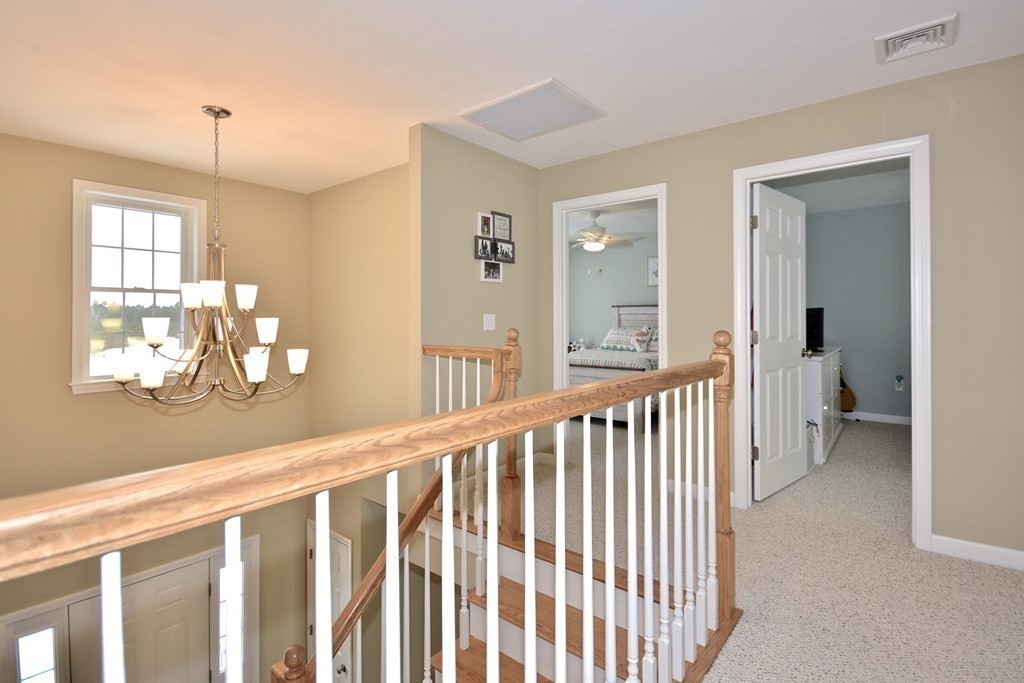 Lot 58-235 Forbes Road Rochester, MA 02770 - Photo 8 of 12 a view of a hallway with wooden floor and windows
