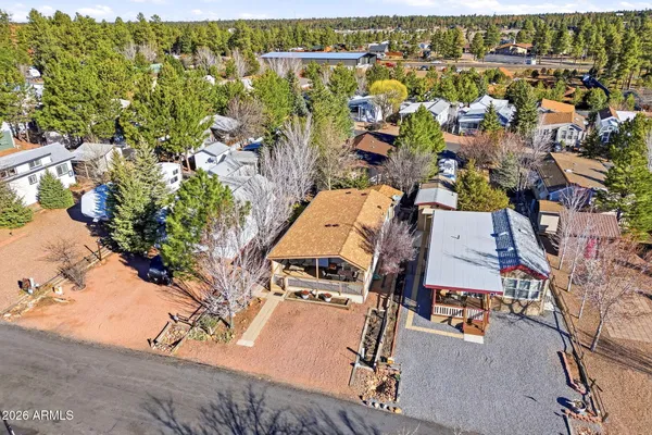 a front view of a house with a tree