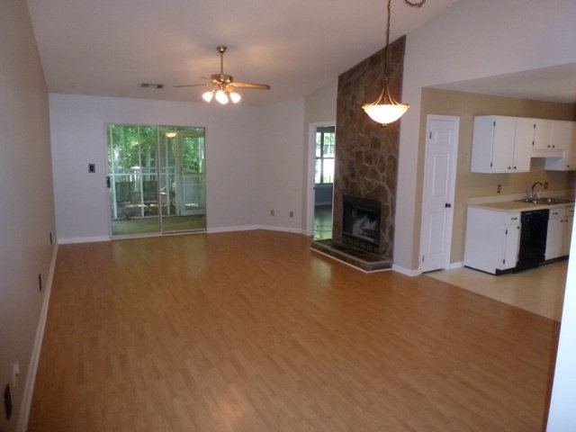 130 Wesleyan Way Macon, GA 31210 - Photo 2 of 9 a view of an empty room with a fireplace and a window