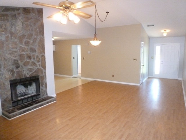 130 Wesleyan Way Macon, GA 31210 - Photo 3 of 9 a view of an empty room with wooden floor fireplace and a window