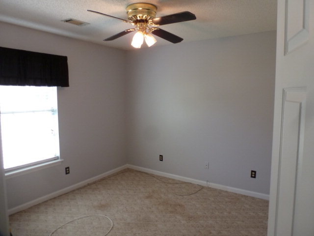 130 Wesleyan Way Macon, GA 31210 - Photo 7 of 9 an empty room with a window and a fan