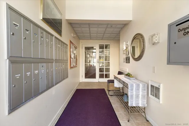 a view of a hallway with wooden floor and a large window