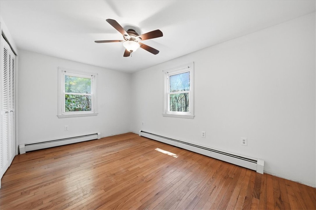 322 Rocky Hill Road Scituate, RI 02857 - Photo 31 of 50 Clean, bright, and airy , Bedroom 1 features hardwood floors and a ceiling fan. Great natural light from multiple windows.