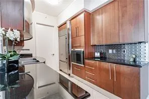 a kitchen with stainless steel appliances granite countertop a sink a stove and a refrigerator
