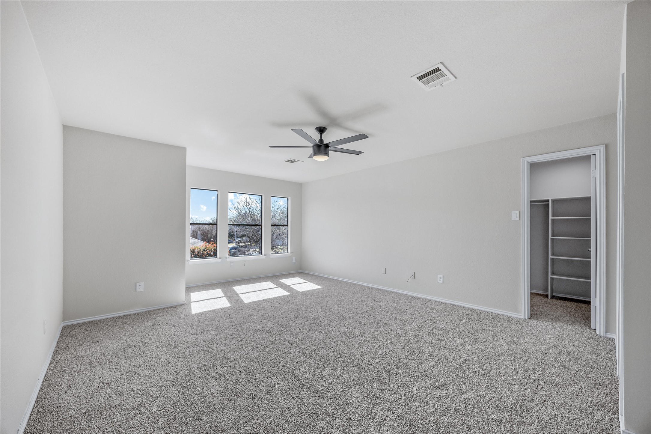7541 Redrick Drive Austin, TX 78747 - Photo 28 of 40 Empty room with baseboards, carpet, visible vents, and ceiling fan