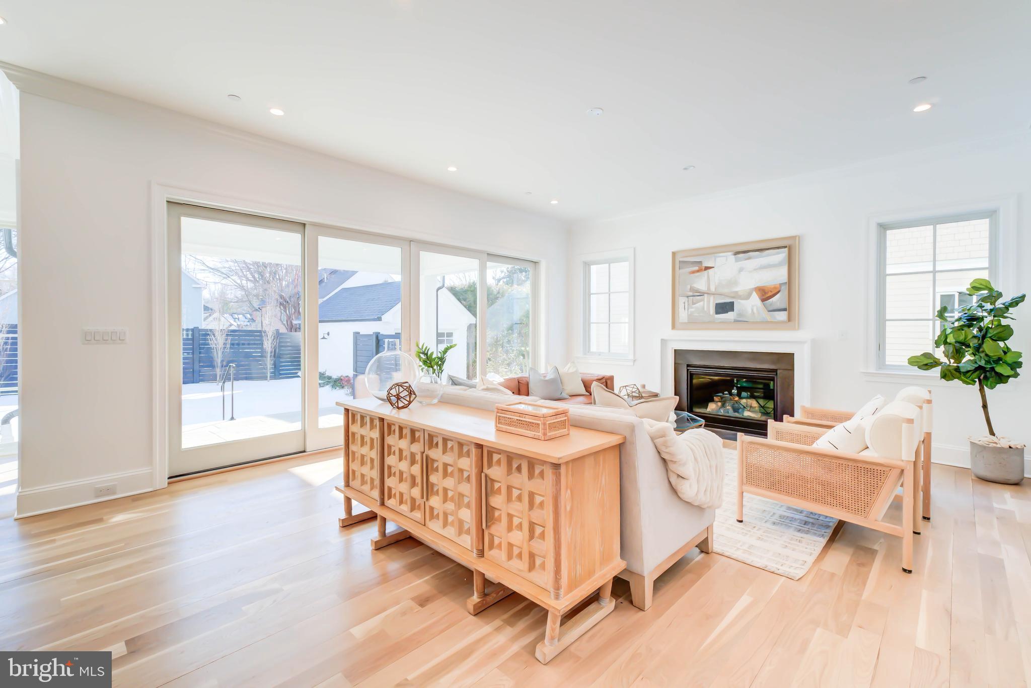4422 Walsh Street Chevy Chase, MD 20815 - Photo 31 of 93 a living room with furniture a fireplace and a floor to ceiling window