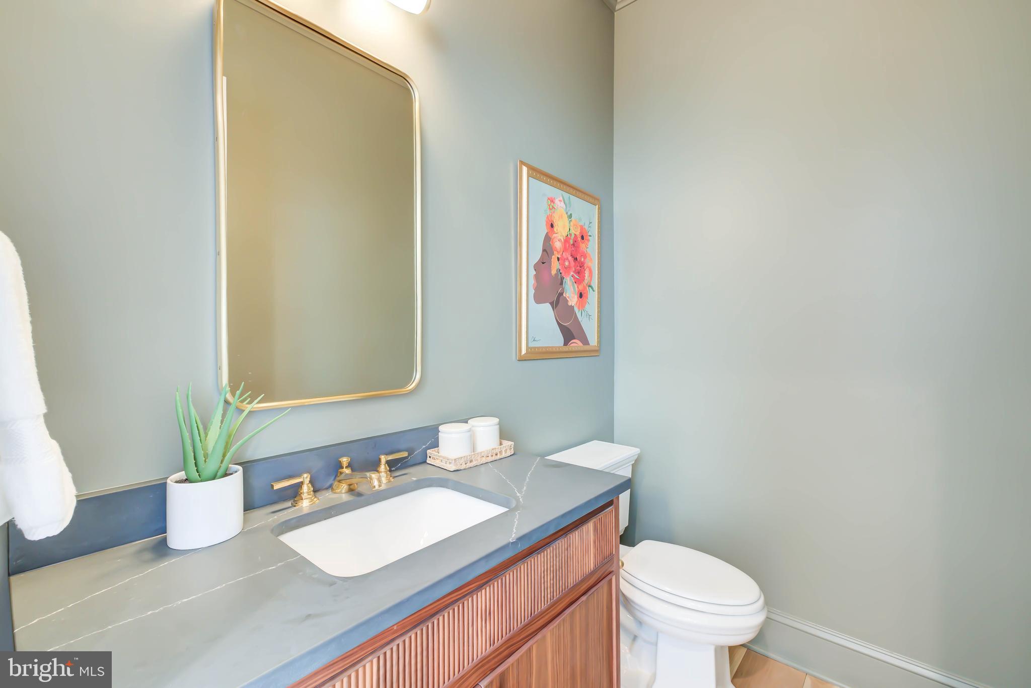 4422 Walsh Street Chevy Chase, MD 20815 - Photo 38 of 93 a bathroom with a granite countertop sink mirror vanity and toilet
