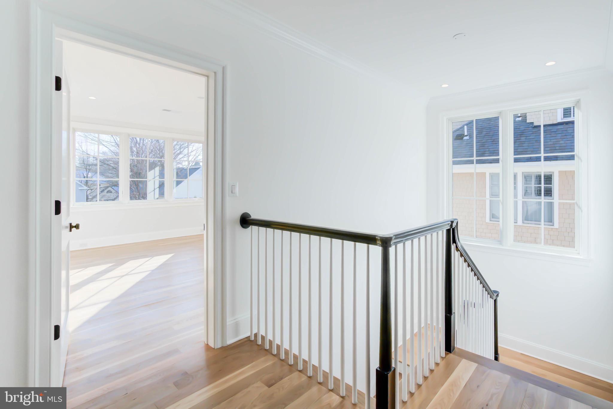 4422 Walsh Street Chevy Chase, MD 20815 - Photo 41 of 93 a view of a hallway with wooden floor and entryway