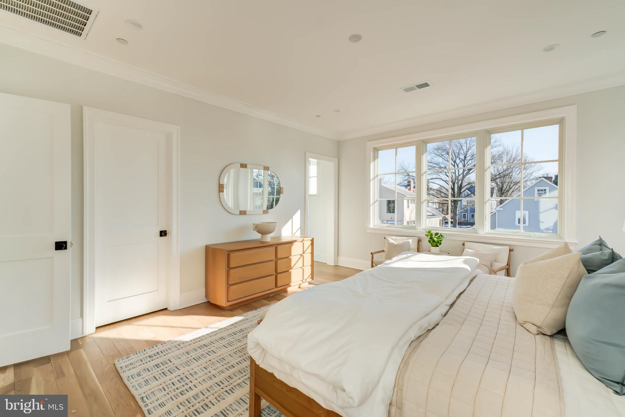 4422 Walsh Street Chevy Chase, MD 20815 - Photo 47 of 93 a spacious bedroom with a bed and a dresser