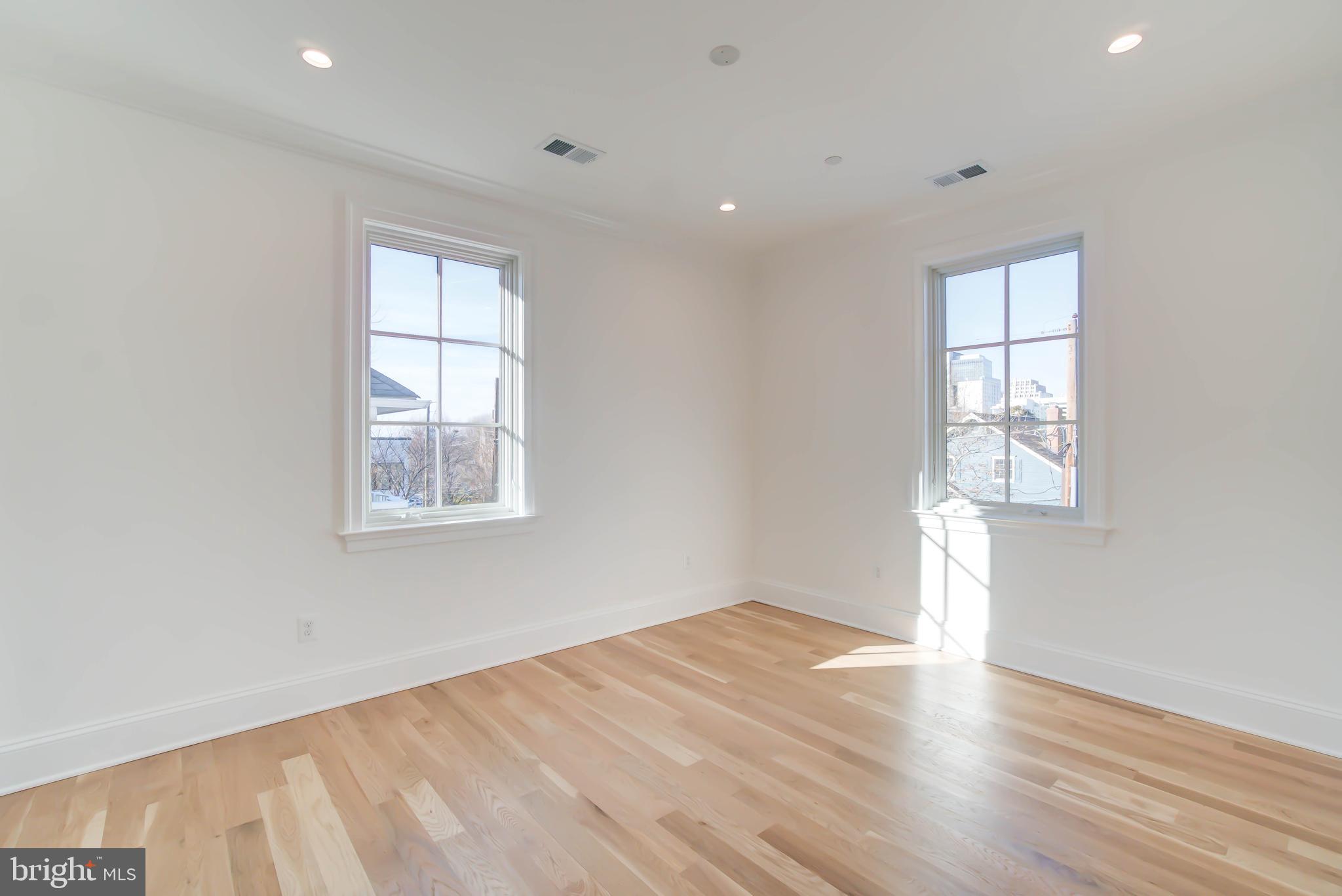 4422 Walsh Street Chevy Chase, MD 20815 - Photo 62 of 93 an empty room with wooden floor and windows