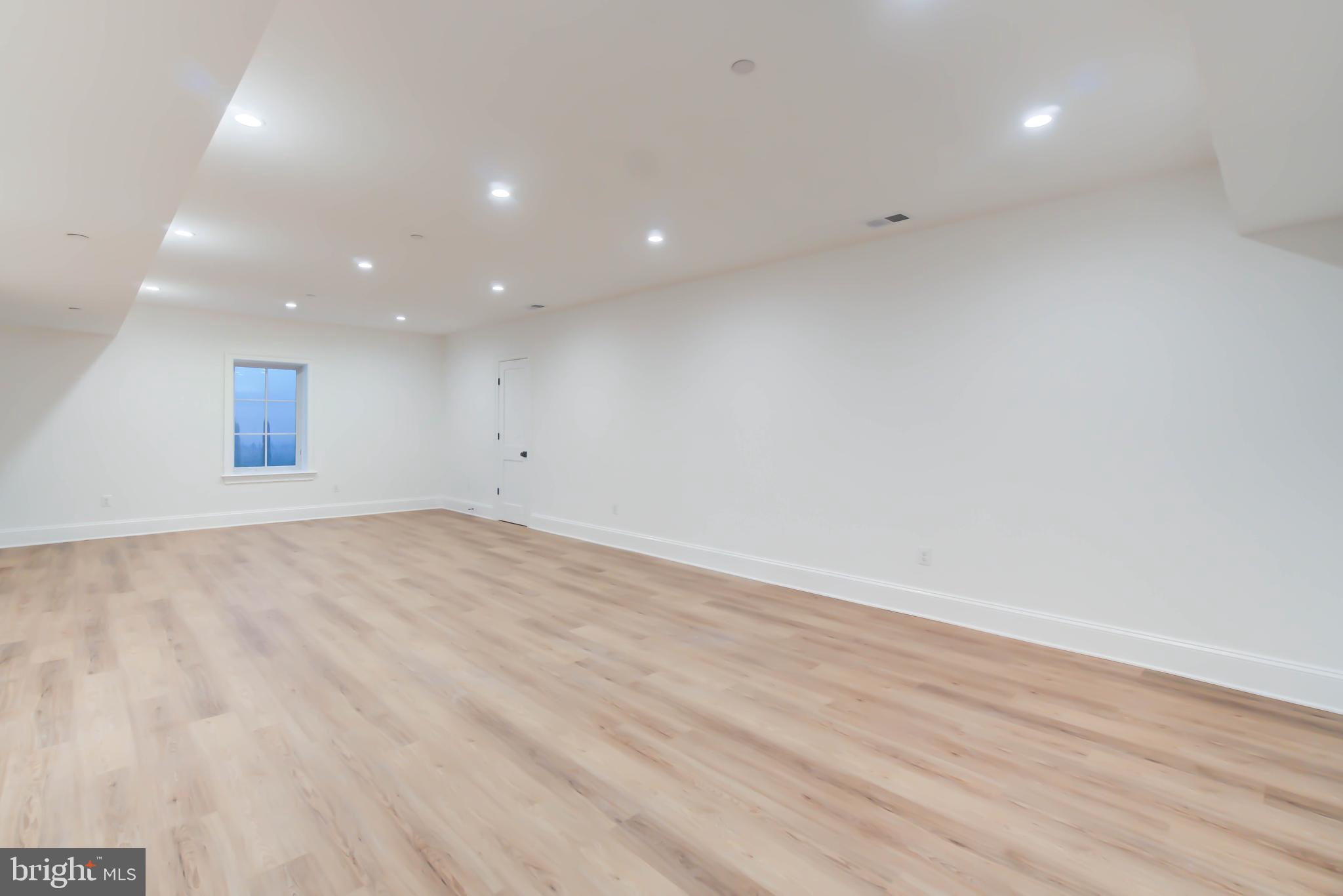 4422 Walsh Street Chevy Chase, MD 20815 - Photo 73 of 93 an empty room with wooden floor and windows
